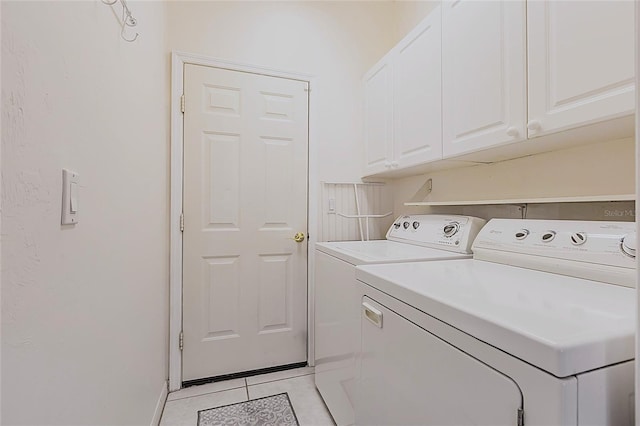 2105 Deborah Dr, Punta Gorda, FL 33950 - laundry room with washing machine and clothes dryer, light tile patterned floors, and cabinet space