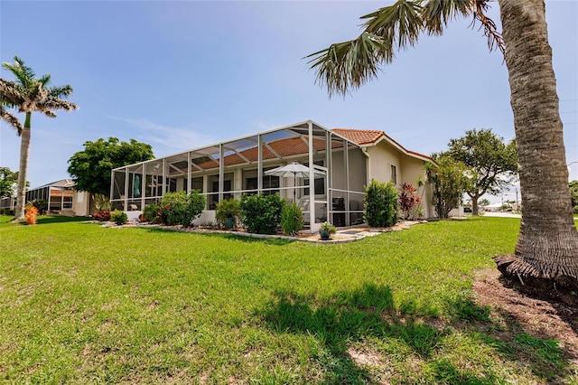 2105 Deborah Dr, Punta Gorda, FL 33950 - rear view of house with stucco siding, a yard, and a tiled roof