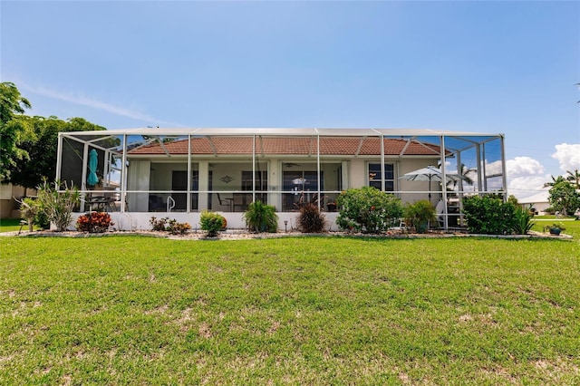 2105 Deborah Dr, Punta Gorda, FL 33950 - back of property featuring a lawn, a tiled roof, a lanai, and stucco siding