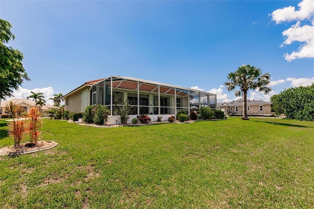 2105 Deborah Dr, Punta Gorda, FL 33950 - back of property featuring a lawn, glass enclosure, and stucco siding