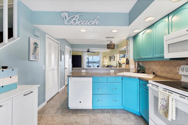26310 Rampart Blvd Unit 504, Punta Gorda, FL 33983 - kitchen featuring white appliances, a peninsula, decorative backsplash, recessed lighting, and ceiling fan