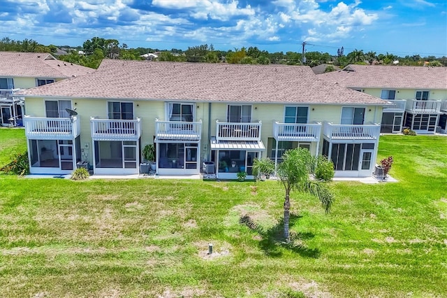 26310 Rampart Blvd Unit 504, Punta Gorda, FL 33983 - rear view of house with a sunroom, a lawn, and a shingled roof