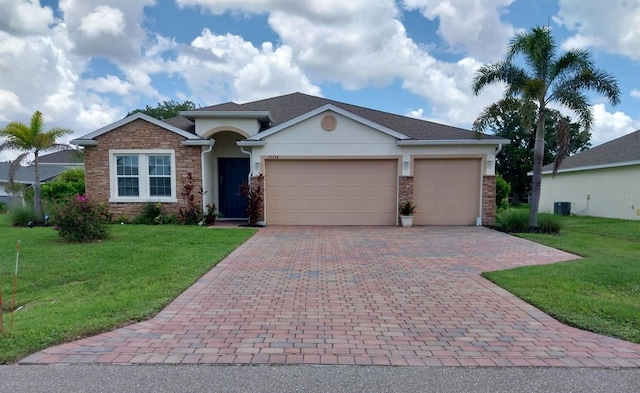 25224 Lahore Ln, Punta Gorda, FL 33983 - ranch-style house featuring stone siding, a garage, decorative driveway, and a front lawn