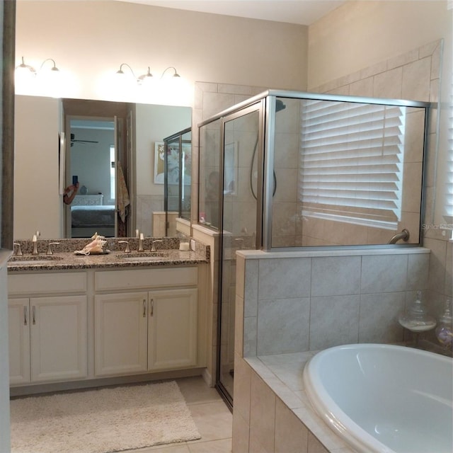 25224 Lahore Ln, Punta Gorda, FL 33983 - ensuite bathroom with double vanity, a bath, a shower stall, and tile patterned floors