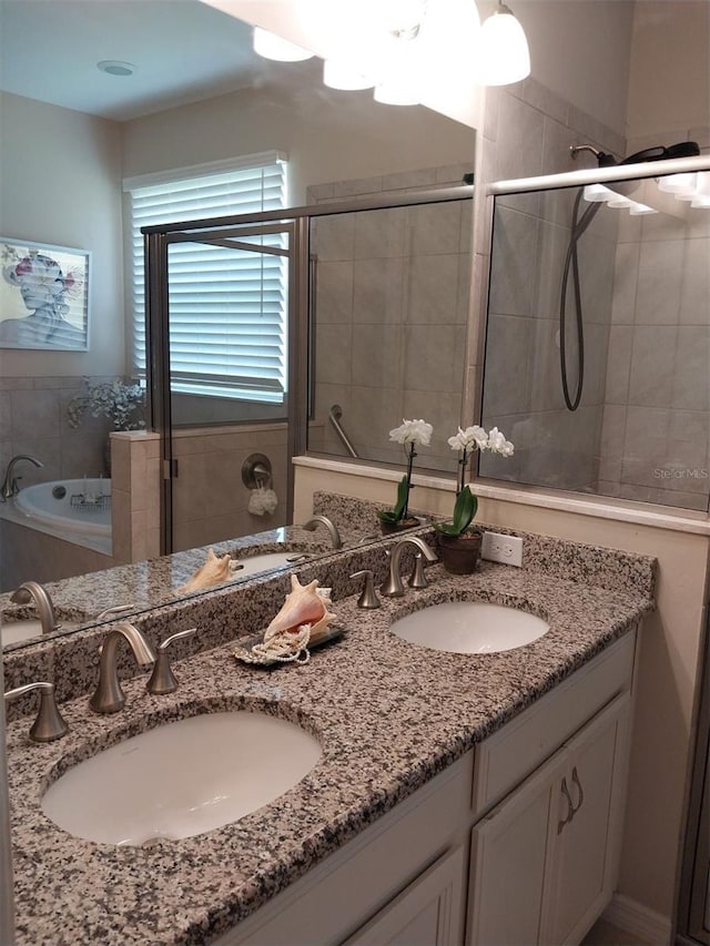 25224 Lahore Ln, Punta Gorda, FL 33983 - full bathroom with double vanity, a shower stall, and a bath