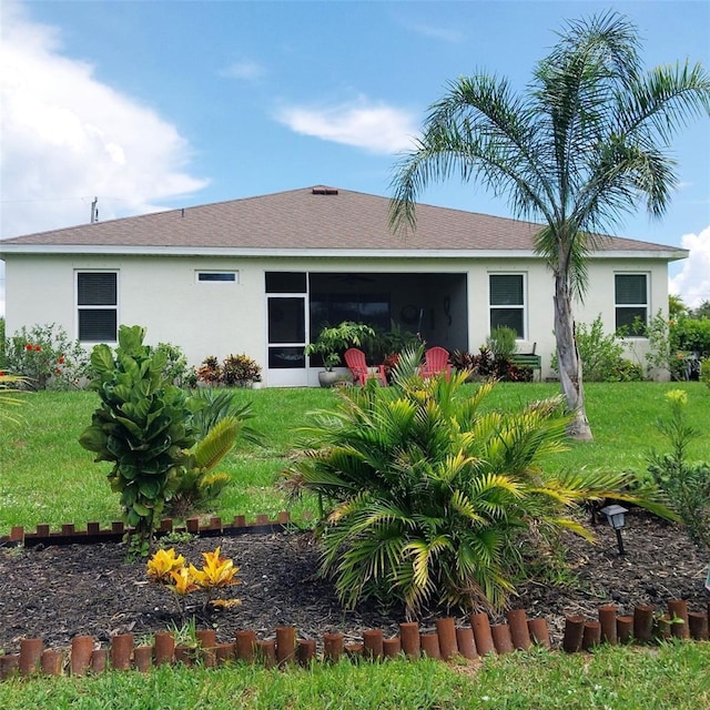 25224 Lahore Ln, Punta Gorda, FL 33983 - rear view of property featuring stucco siding, a yard, and a sunroom