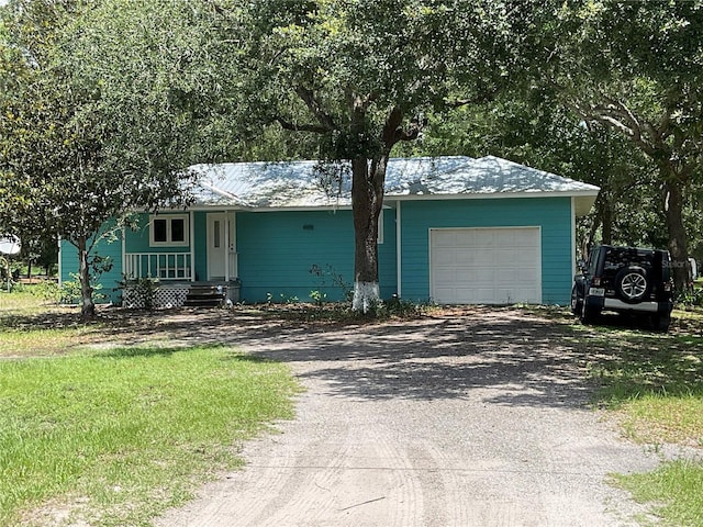 3895 Sunset Dr, Zolfo Springs, FL 33890 - view of front facade with dirt driveway and an attached garage