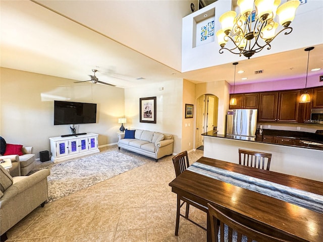 11220 Paseo Grande Blvd Unit 5207, Fort Myers, FL 33912 - living area with arched walkways, ceiling fan, a chandelier, light tile patterned floors, and a towering ceiling