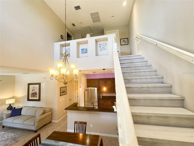 11220 Paseo Grande Blvd Unit 5207, Fort Myers, FL 33912 - stairway with a chandelier and a high ceiling
