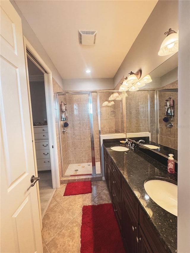 11220 Paseo Grande Blvd Unit 5207, Fort Myers, FL 33912 - bathroom with a shower stall, tile patterned floors, double vanity, and a walk in closet