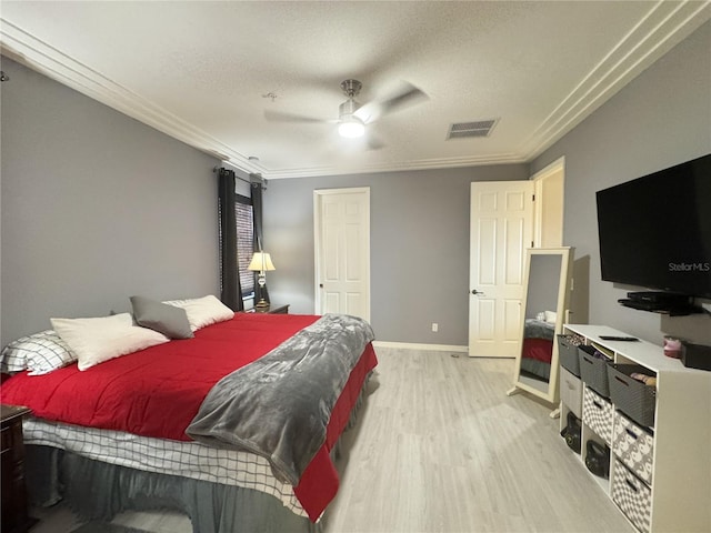 11220 Paseo Grande Blvd Unit 5207, Fort Myers, FL 33912 - bedroom with light wood-style flooring, ornamental molding, a ceiling fan, and a textured ceiling