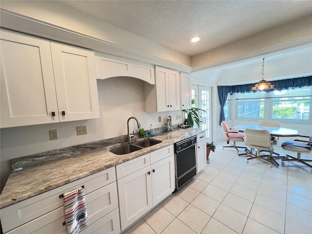 2526 Brazilia Ct, Punta Gorda, FL 33950 - kitchen with dishwasher, white cabinets, a textured ceiling, light tile patterned floors, and hanging light fixtures