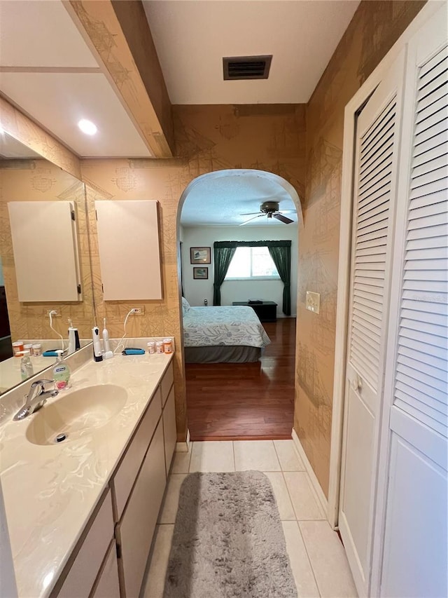 2526 Brazilia Ct, Punta Gorda, FL 33950 - bathroom featuring a closet, vanity, a ceiling fan, tile patterned floors, and connected bathroom