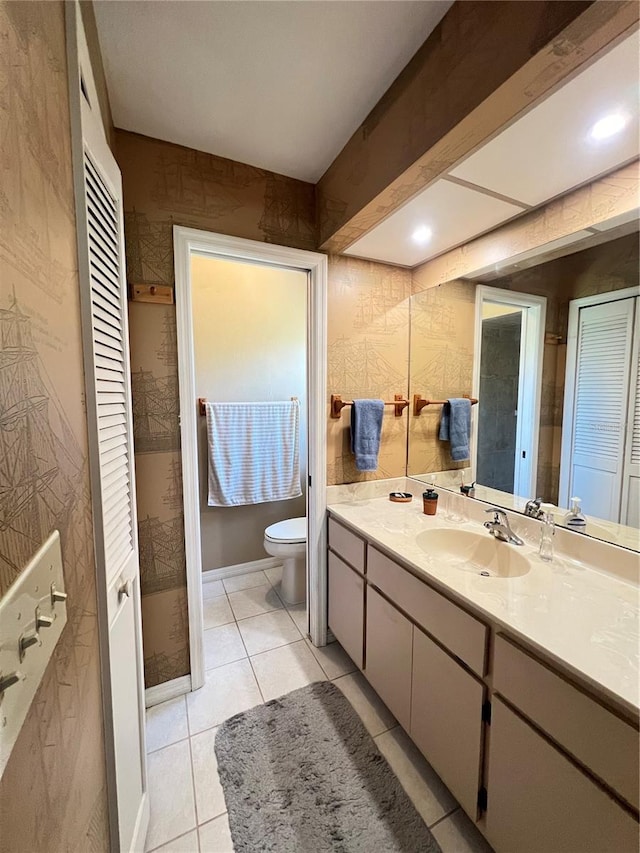 2526 Brazilia Ct, Punta Gorda, FL 33950 - bathroom with vanity, wallpapered walls, tile patterned flooring, and a closet