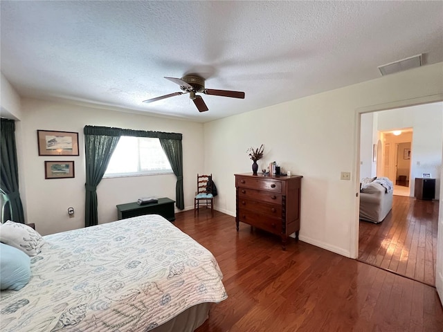 2526 Brazilia Ct, Punta Gorda, FL 33950 - bedroom with a textured ceiling, dark wood-style floors, and a ceiling fan