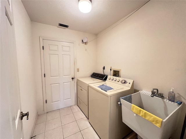 2526 Brazilia Ct, Punta Gorda, FL 33950 - laundry room featuring washing machine and dryer, light tile patterned flooring, and a textured ceiling