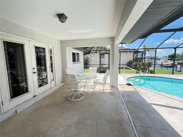 2526 Brazilia Ct, Punta Gorda, FL 33950 - swimming pool featuring a patio area, glass enclosure, and a water view