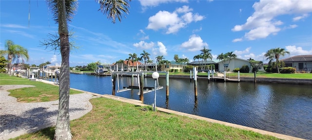 2526 Brazilia Ct, Punta Gorda, FL 33950 - dock area with boat lift, a water view, a residential view, and a lawn