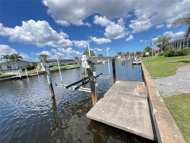 2526 Brazilia Ct, Punta Gorda, FL 33950 - dock featuring boat lift, a water view, and a yard
