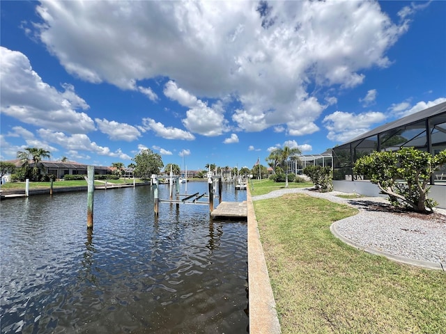 2526 Brazilia Ct, Punta Gorda, FL 33950 - dock area featuring boat lift, a water view, and a lawn