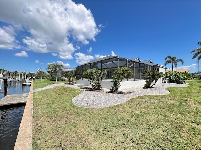 2526 Brazilia Ct, Punta Gorda, FL 33950 - view of green lawn with a dock, a water view, and glass enclosure