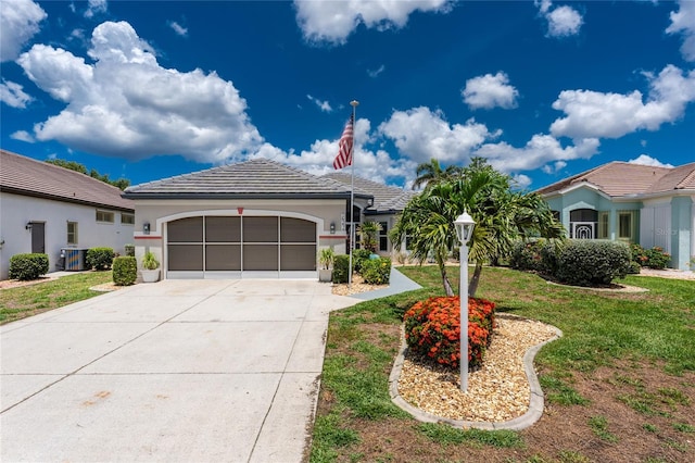 26254 Stillwater Cir, Punta Gorda, FL 33955 - view of front facade featuring an attached garage, driveway, a tile roof, stucco siding, and a front lawn