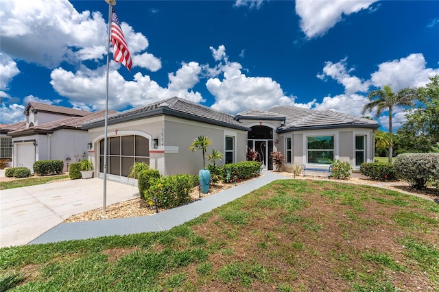 26254 Stillwater Cir, Punta Gorda, FL 33955 - single story home with an attached garage, concrete driveway, stucco siding, a tile roof, and a front yard