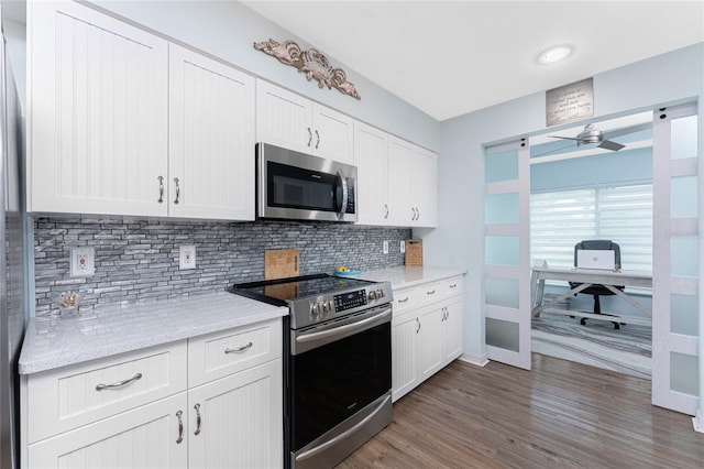 26254 Stillwater Cir, Punta Gorda, FL 33955 - kitchen featuring appliances with stainless steel finishes, tasteful backsplash, a ceiling fan, and dark wood-style floors