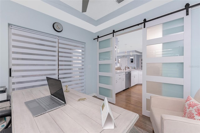 26254 Stillwater Cir, Punta Gorda, FL 33955 - home office featuring a barn door and wood finished floors