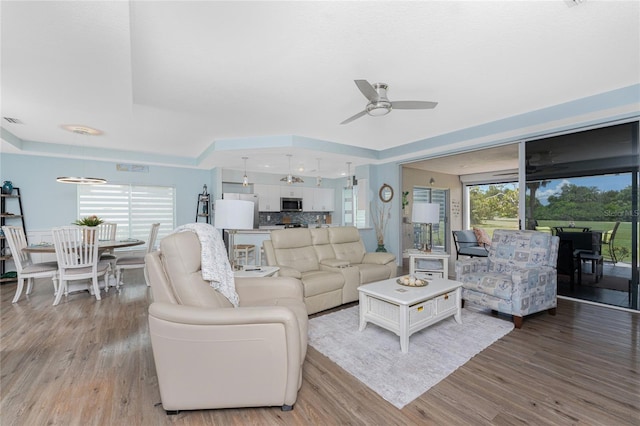 26254 Stillwater Cir, Punta Gorda, FL 33955 - living area with a ceiling fan and light wood-style flooring