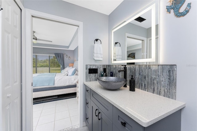 26254 Stillwater Cir, Punta Gorda, FL 33955 - ensuite bathroom featuring vanity, backsplash, and tile patterned floors