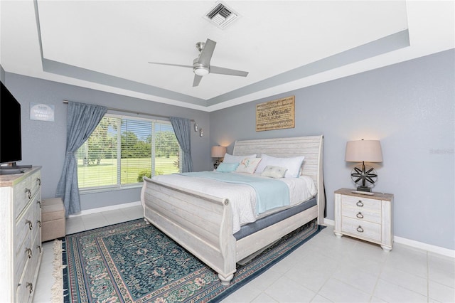 26254 Stillwater Cir, Punta Gorda, FL 33955 - bedroom with a tray ceiling, ceiling fan, and light tile patterned floors