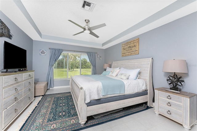 26254 Stillwater Cir, Punta Gorda, FL 33955 - bedroom with a raised ceiling, a ceiling fan, and light tile patterned flooring