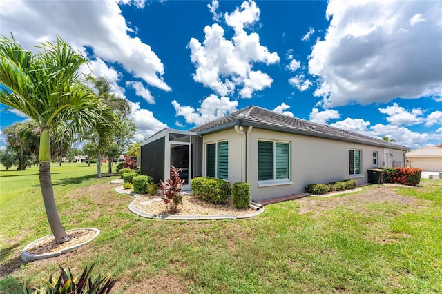 26254 Stillwater Cir, Punta Gorda, FL 33955 - view of side of home featuring stucco siding, a lawn, and a lanai