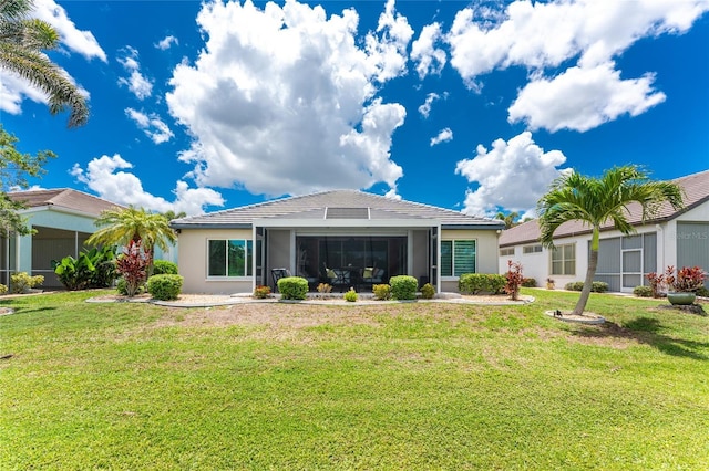 26254 Stillwater Cir, Punta Gorda, FL 33955 - back of property with a lawn, stucco siding, and a sunroom