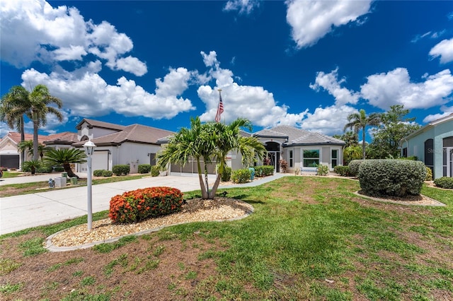 26254 Stillwater Cir, Punta Gorda, FL 33955 - view of front of property featuring driveway, an attached garage, and a front yard
