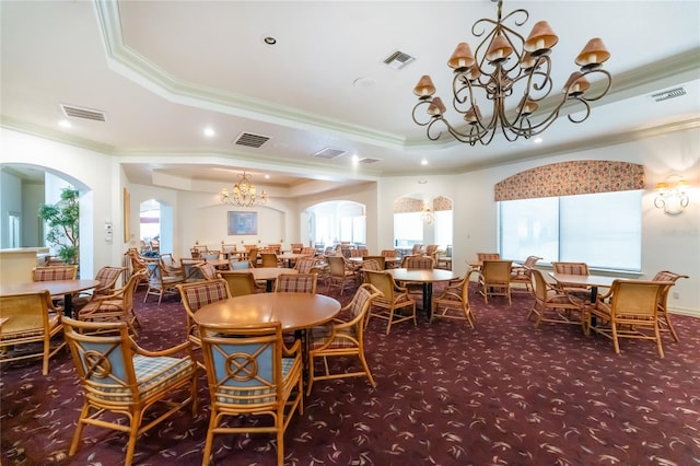26254 Stillwater Cir, Punta Gorda, FL 33955 - dining space with a chandelier, ornamental molding, a raised ceiling, arched walkways, and healthy amount of natural light
