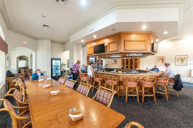 26254 Stillwater Cir, Punta Gorda, FL 33955 - carpeted dining room featuring arched walkways, ornamental molding, recessed lighting, and a community bar