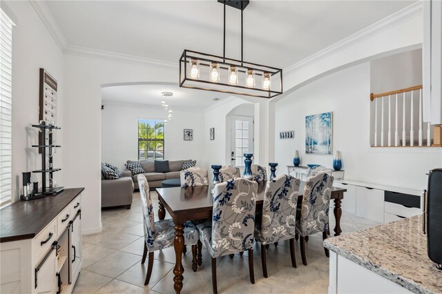 11105 Balfour St E, Venice, FL 34293 - dining area with arched walkways, crown molding, and light tile patterned floors