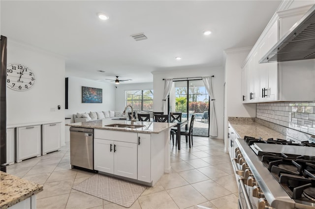 11105 Balfour St E, Venice, FL 34293 - kitchen with stainless steel dishwasher, exhaust hood, stove, open floor plan, and white cabinets