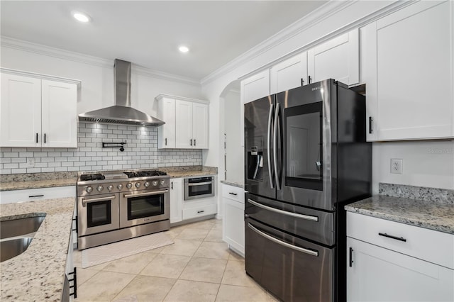 11105 Balfour St E, Venice, FL 34293 - kitchen with fridge with ice dispenser, wall chimney exhaust hood, double oven range, white cabinets, and crown molding