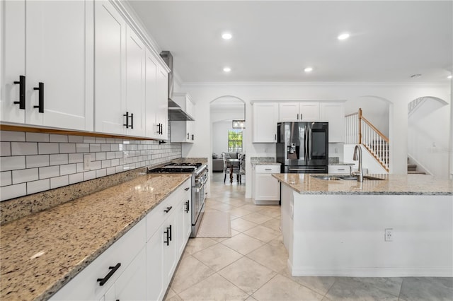 11105 Balfour St E, Venice, FL 34293 - kitchen featuring refrigerator with ice dispenser, stainless steel range, arched walkways, light stone counters, and crown molding