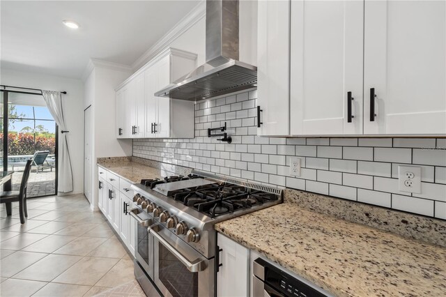 11105 Balfour St E, Venice, FL 34293 - kitchen featuring wall chimney exhaust hood, double oven range, crown molding, light stone counters, and white cabinets