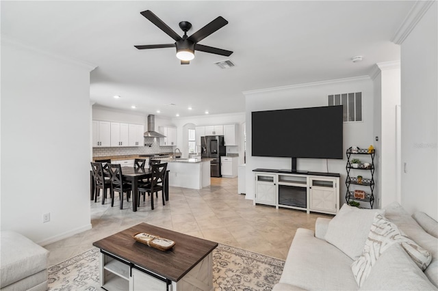 11105 Balfour St E, Venice, FL 34293 - living room with ornamental molding, a ceiling fan, and recessed lighting