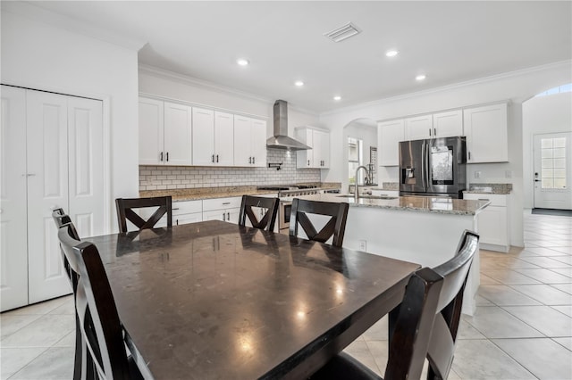 11105 Balfour St E, Venice, FL 34293 - dining space with light tile patterned flooring, crown molding, arched walkways, and recessed lighting