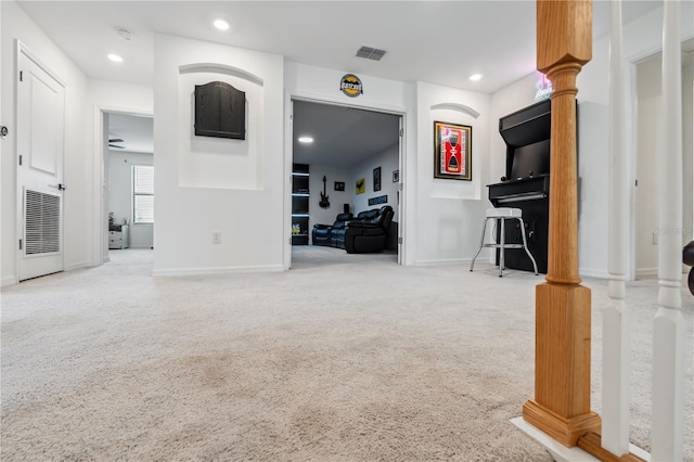 11105 Balfour St E, Venice, FL 34293 - unfurnished living room with carpet floors, ornate columns, and recessed lighting