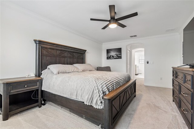 11105 Balfour St E, Venice, FL 34293 - bedroom featuring arched walkways, crown molding, light carpet, ceiling fan, and ensuite bath