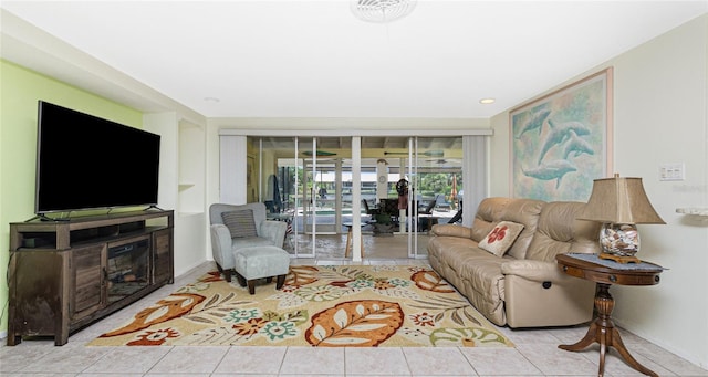 4051 Rock Creek Dr, Port Charlotte, FL 33948 - living area with tile patterned floors and a glass covered fireplace