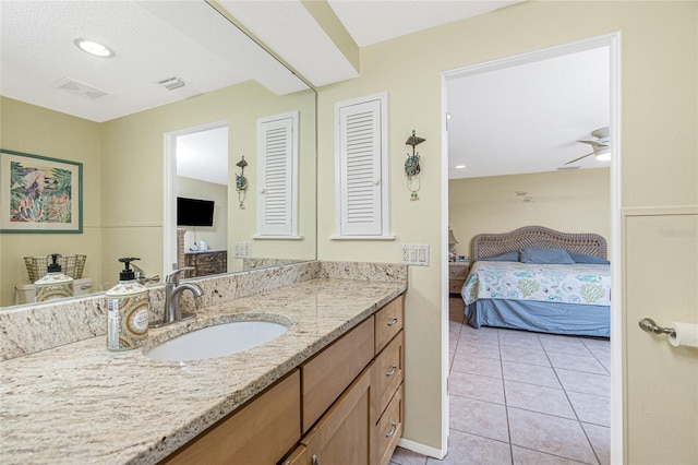 4051 Rock Creek Dr, Port Charlotte, FL 33948 - ensuite bathroom featuring vanity, a ceiling fan, and tile patterned floors