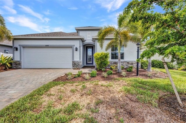 16848 Canopy Garden Dr, Port Charlotte, FL 33953 - view of front of home featuring stone siding, stucco siding, and a garage